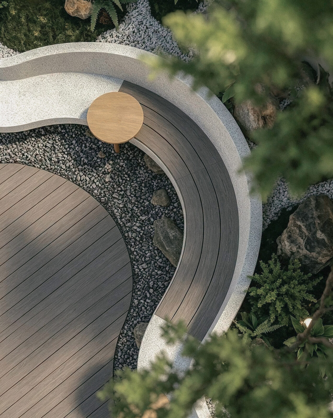 Overhead view of a curved courtyard deck, stone bench and garden planting